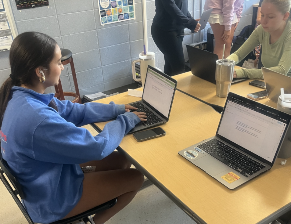 Ava Muzumdar (11) and Ella Peabody (11) work on assignments in LEGACY period. 
